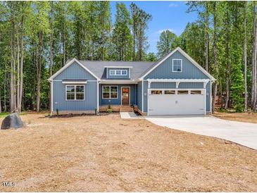 Beautiful single-story home featuring a two-car garage and a well-manicured front lawn at 9231 Bear Run Ln, Middlesex, NC 27557