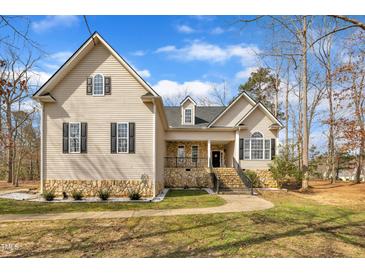 Charming two-story home with stone accents, inviting front porch and well-manicured lawn at 10 Holden Ct, Youngsville, NC 27596