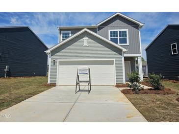 Charming gray two-story home with a two-car garage and a well-manicured lawn in a friendly neighborhood at 105 Gabriel Ct, Clayton, NC 27520