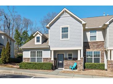 Charming townhome exterior with stone accents and a well-maintained landscaped yard at 114 Mt Evans Dr, Durham, NC 27705