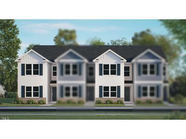 New construction townhomes boast modern exteriors with classic design elements and manicured landscaping at 123 Holmes Corner Dr, Smithfield, NC 27577