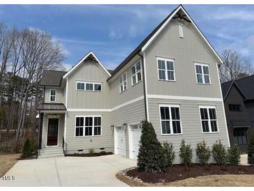 Beautiful two-story home with a well-manicured lawn and a two-car garage at 12912 Grey Willow Dr, Raleigh, NC 27613