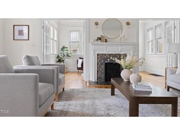 Bright living room with a fireplace and hardwood floors at 201 W Trinity Ave, Durham, NC 27701
