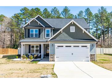 Charming two-story home with a well-manicured lawn and an attached two-car garage at 238 Ashpole Trail Trl, Clayton, NC 27520