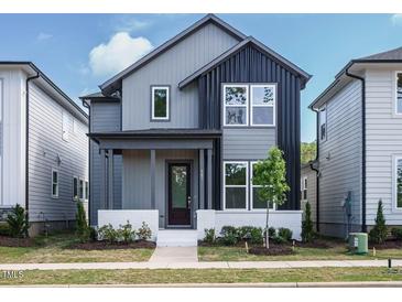 Charming two-story home with a covered porch, gray siding, and modern design at 267 Parkland Dr Dr, Pittsboro, NC 27312