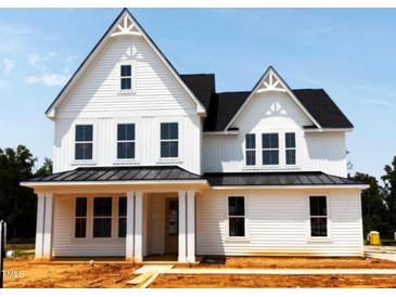 New two-story home with white siding, black roof and trim, and a welcoming front porch at 3200 Balcon Ct # 28, Angier, NC 27501