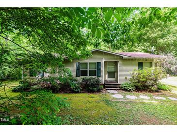 Charming single-story home featuring a well-manicured lawn and tasteful landscaping at 441 Wintergreen Rd, Timberlake, NC 27583