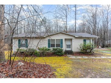 Charming single-story home with green shutters surrounded by a wooded landscape at 441 Wintergreen Rd, Timberlake, NC 27583