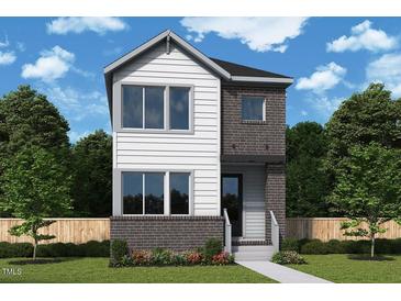 Two-story home with white siding, brick accents, professional landscaping, and a welcoming entryway at 46 Rainfall Dr, Pittsboro, NC 27312