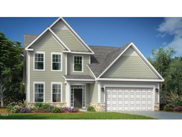 Charming two-story home with a manicured lawn, a gray roof, and an attached two-car garage at 580 Winding Creek Dr, Lillington, NC 27546