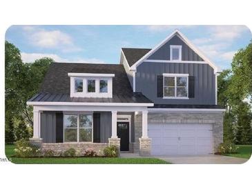 Charming two-story home featuring stone accents, a covered porch, and a two-car garage, nestled in a beautifully landscaped community at 7568 Percussion Dr, Apex, NC 27539