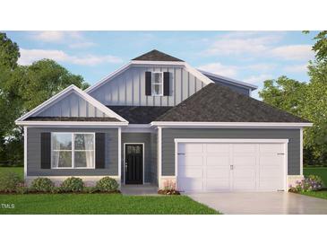 Charming single-Gathering home with a two-car garage, lush lawn and neutral-tone siding at 7573 Percussion Dr, Apex, NC 27539