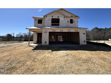 Exterior view of new construction featuring a covered garage, situated on a spacious lot, awaiting customization at 9 W Emily Gardens Dr, Selma, NC 27576