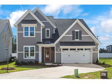 Beautiful two-story home featuring gray siding, black shutters, and a two-car garage at 9173 Dupree Meadow Ct # 25, Angier, NC 27501