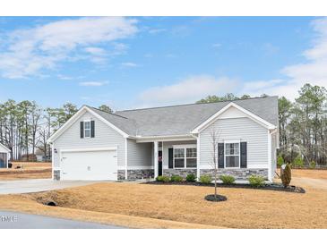 Charming single-Gathering home with attached garage, neutral siding, and well-kept landscaping at 295 Barbour Farm Ln, Four Oaks, NC 27524