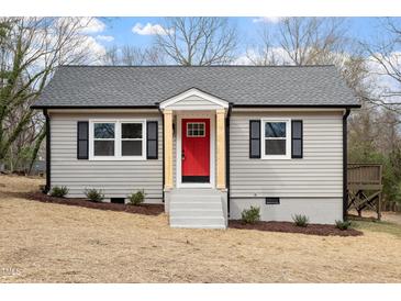 Charming renovated single-story home with a gray exterior, red front door, and simple landscaping at 312 W Union St, Hillsborough, NC 27278