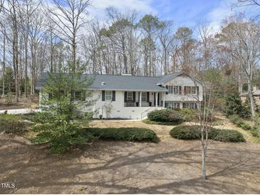 Charming single-Gathering home featuring a landscaped front yard, black shutters, and a classic white exterior at 400 Edinburgh Dr, Cary, NC 27511