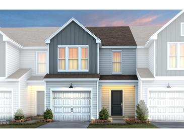 Charming townhome featuring a two-car garage, craftsman details and manicured landscaping at 4002 Kidd Pl, Durham, NC 27703