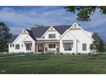 Beautiful modern farmhouse with white siding, gabled roof, covered porch, and well-manicured lawn at 4060 Granite Ridge Trl, Raleigh, NC 27616