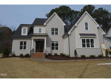 Charming two-story home featuring a gray painted brick exterior and a beautifully landscaped front yard at 505 Ansley Ridge Rdg, Cary, NC 27518