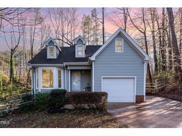 Charming home with a well-manicured front yard, attached garage, and inviting curb appeal at 6800 Chamonix Pl, Raleigh, NC 27613