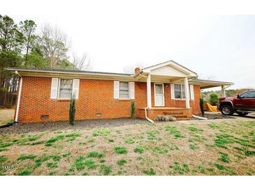 Charming brick home featuring a covered porch and carport on a well-maintained lot at 10166 Buffalo Rd, Clayton, NC 27527