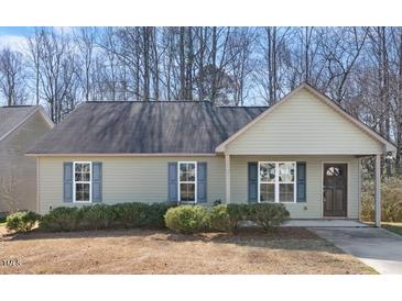 Charming single-story home features a cozy front porch and blue shutters at 220 Courtland Dr, Angier, NC 27501
