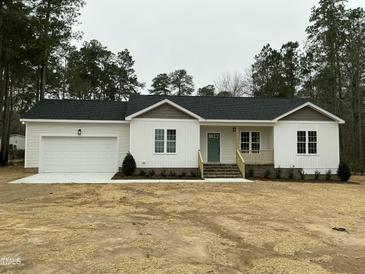 Charming single-story home featuring a two-car garage and a welcoming covered porch at 2242 Eldridge Rd, Newton Grove, NC 28366