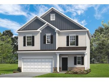 Charming two-story home featuring a classic design and beautiful curb appeal with well-manicured lawn at 275 Deodora Ln, Cameron, NC 28326