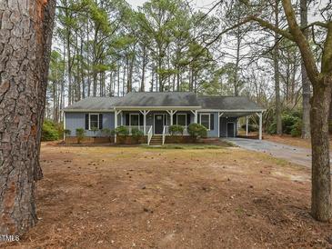 Charming single-story home featuring a covered front porch and well-maintained landscaping at 314 Mill Creek Dr, Fuquay Varina, NC 27526