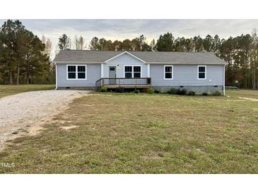 Charming one-story home with gray siding, front porch, and inviting curb appeal at 349 Tristen Ln, Henderson, NC 27537