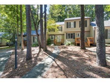 Exterior view of a townhome with beautiful trees and a sidewalk leading to the front door at 502 Forest Court, Carrboro, NC 27510
