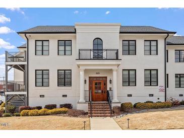 Stunning three-story building with a light brick exterior, black trim, and a welcoming entrance at 605 Smedes Pl # B, Raleigh, NC 27605