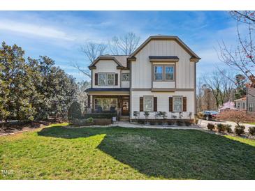 Charming two-story home boasts a manicured lawn, beautiful landscaping, and inviting curb appeal at 1209 Kingston Ridge Rd, Cary, NC 27511