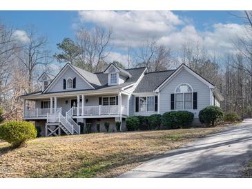 Charming gray home with a welcoming front porch and well-maintained landscaping at 180 Normandy Rd, Louisburg, NC 27549