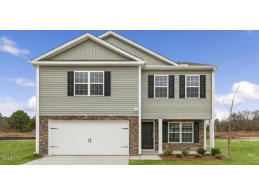 Charming two-story home with stone accents, black shutters, and a two-car garage at 209 Leven Dr, Gibsonville, NC 27249