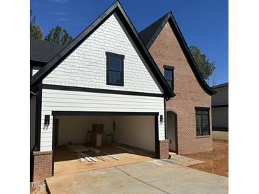 Charming new construction home with a two-car garage, brick facade, and modern design at 230 Sutherland Dr, Franklinton, NC 27525