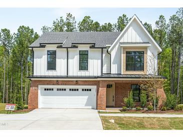 Charming two-story home with a brick and white facade, and a two-car garage at 240 Sutherland Dr, Franklinton, NC 27525