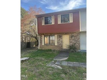 Inviting two-story townhome with brick and siding, complemented by a quaint front yard at 2408 Stadium Dr # A, Durham, NC 27704
