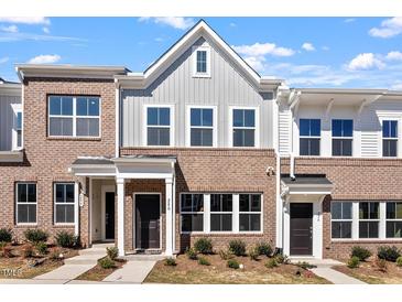 Charming brick townhomes with well-maintained landscaping and inviting front entrances offer curb appeal at 280 Chesapeake Commons St # 151, Garner, NC 27529