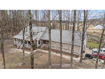 Charming home with a cozy front porch, set among mature trees at 3405 Wilsons Mills Rd, Smithfield, NC 27577
