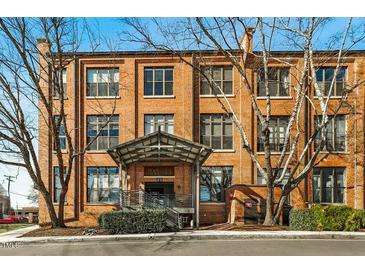 Charming brick condominium building with covered entrance, well-maintained landscaping, and mature trees at 500 N Duke St # 53104, Durham, NC 27701