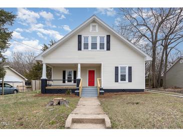 Charming two-story home featuring a welcoming front porch and a freshly painted red front door at 636 Tucker St, Burlington, NC 27215