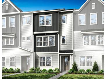 Modern townhome showcasing a dark and light siding and a manicured lawn at 1036 Zelkova Ln, Chapel Hill, NC 27517