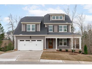Charming two-story home featuring a gray exterior, white trim, covered porch, and a two-car garage at 116 Pointe Park Cir, Holly Springs, NC 27540