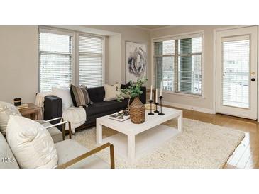 Cozy living room featuring neutral colors, lots of natural light, and an inviting seating area at 1210 Westview Ln # 201, Raleigh, NC 27605
