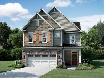 Charming two-story home featuring stone accents, a two-car garage, and a landscaped front yard at 1370 Sparkling Lake Dr # 78, Apex, NC 27523