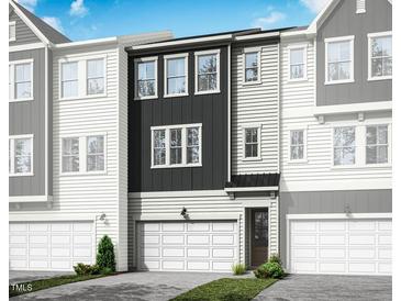 Modern townhome with black and white siding, attached garage and manicured landscaping at 2015 Trident Maple Ln, Chapel Hill, NC 27517