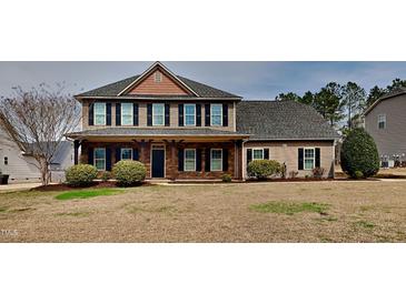 Charming two-story home featuring a welcoming front porch and well-maintained landscaping at 257 Swann Trl, Clayton, NC 27527