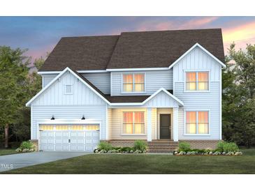 Charming two-story home featuring a two-car garage and a beautifully landscaped front yard at 353 Belmont Stakes Ln, Wendell, NC 27591